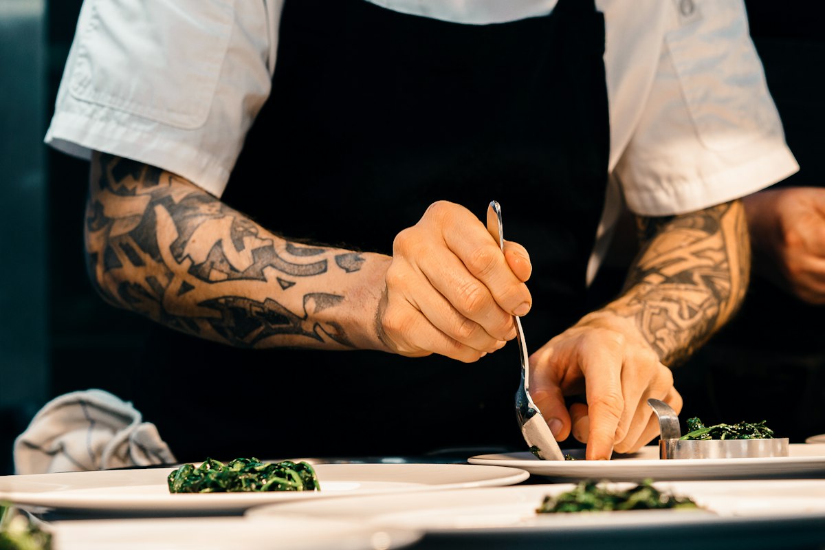Chef plating a dish at the pass